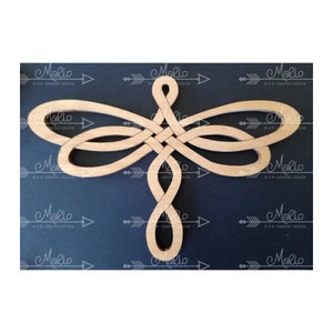 May include: A wooden dragonfly wall decor with a knot design. The dragonfly is made of light brown wood and has a natural finish.