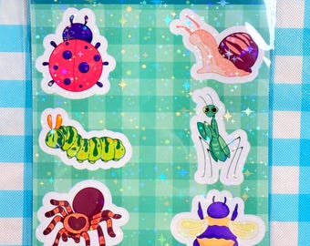 May include: A clear plastic sleeve containing a sheet of bug-themed stickers. The stickers feature colorful illustrations of a ladybug, snail, caterpillar, praying mantis, spider, and bee. The text "BUG STICKER SHEET" is at the top.