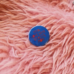 May include: A blue button with red text that reads "I'm in love with Stacy's Mom".