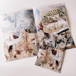 May include: A set of three decorative paper sheets with a collage design. The sheets feature images of a cozy bedroom, a cabin, and a woman by a window. The color palette includes white, beige, and brown tones. One sheet has the text "ME TIME".