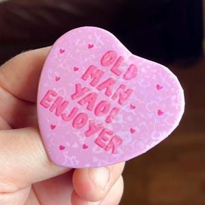 Old Man Yaoi Enjoyer , Holographic Heart Shaped Badge in PINK