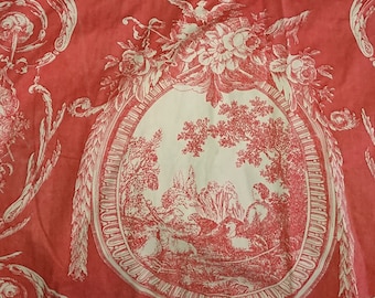 May include: Red fabric with a white toile pattern featuring a repeating design of a stylized oval with a pastoral scene inside. The oval is surrounded by stylized floral and scrollwork.