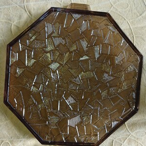 May include: Octagonal glass serving tray with a brown, textured, geometric pattern. The tray has two handles on the sides.