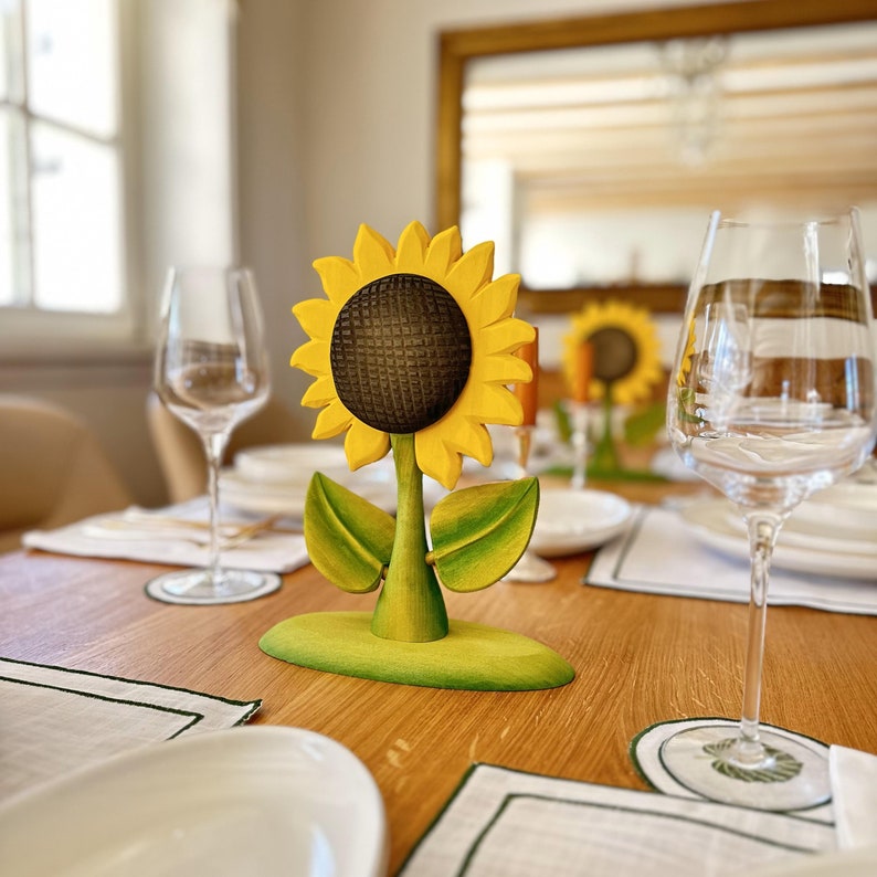 Sustainable wooden sunflower toy adding a playful touch to a dining table set, illustrating its use as a decor piece