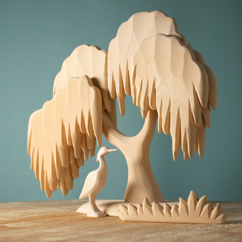 Elegant wooden willow tree in a serene setting with a bird, showcasing its use in storytelling and thematic play for Waldorf and Montessori education.
