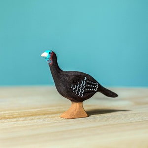 Handcrafted Wooden Turkey Hen Figurine on wooden surface.