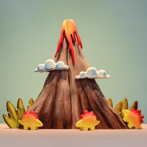 "Imaginative play wooden volcano with red and yellow eruption and cloud pieces, designed for storytelling and geological education.