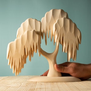 Artisan wooden willow tree showing a human hand for scale, emphasizing the toy’s handcrafted and natural aesthetic for Montessori learning.