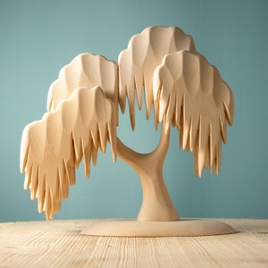 Unadorned wooden willow tree toy on a wooden surface, highlighting the intricate branch design for tactile Montessori education.
