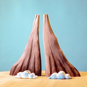 Sustainably made wooden volcano model with a fiery eruption and floating clouds, offering a tactile learning experience for children.