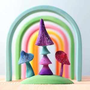 Colorful wooden rainbow puzzle, part of the ARCADE collection, on a wooden surface demonstrating the variety of stacking options.