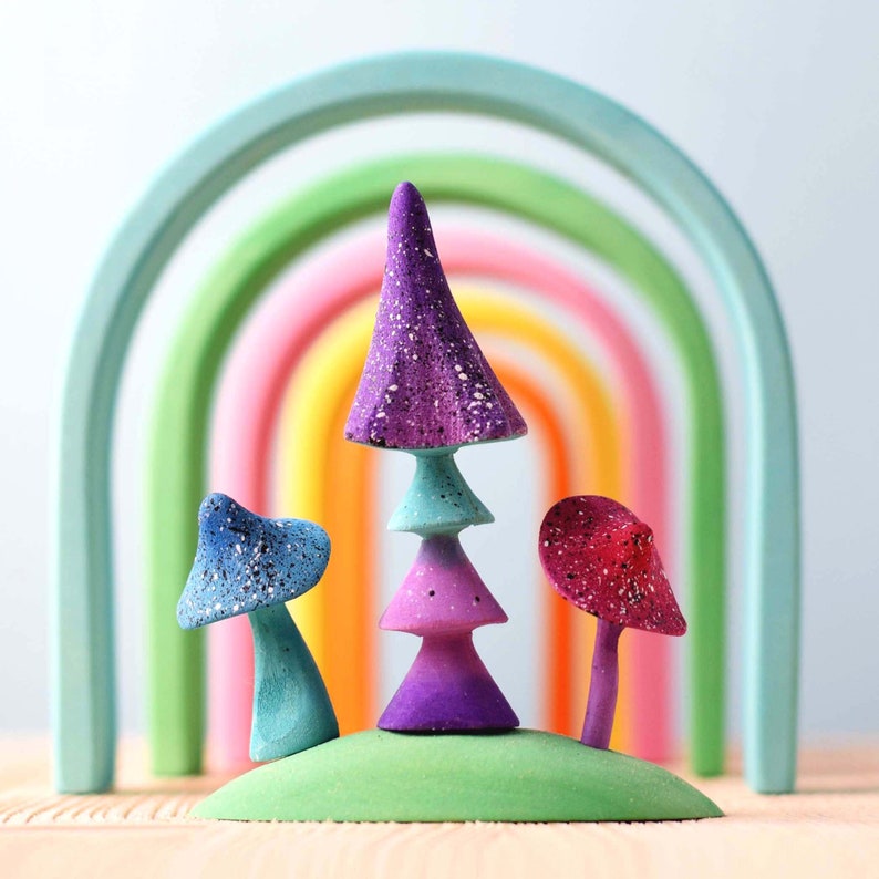 Colorful wooden rainbow puzzle, part of the ARCADE collection, on a wooden surface demonstrating the variety of stacking options.