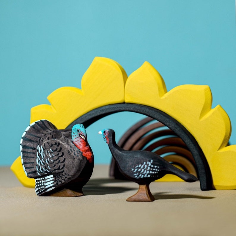 Wooden Turkey Hen Figurine in front of bright sunflower, Montessori-inspired natural play