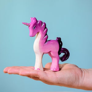 Children's toy: pink unicorn figurine made of wood