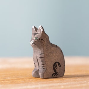 Wooden figure of a grey striped cat with a curious expression and intricate details, perfect for Montessori play and animal recognition.