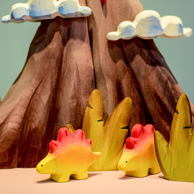 Interactive wooden volcano toy with detachable cloud pieces and painted lava detail, perfect for hands-on learning about geology.