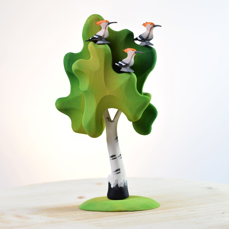 a toy tree with birds on top