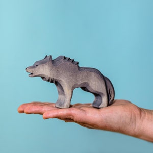 Child playing with the eco-friendly, handcrafted Wolf Angry figurine