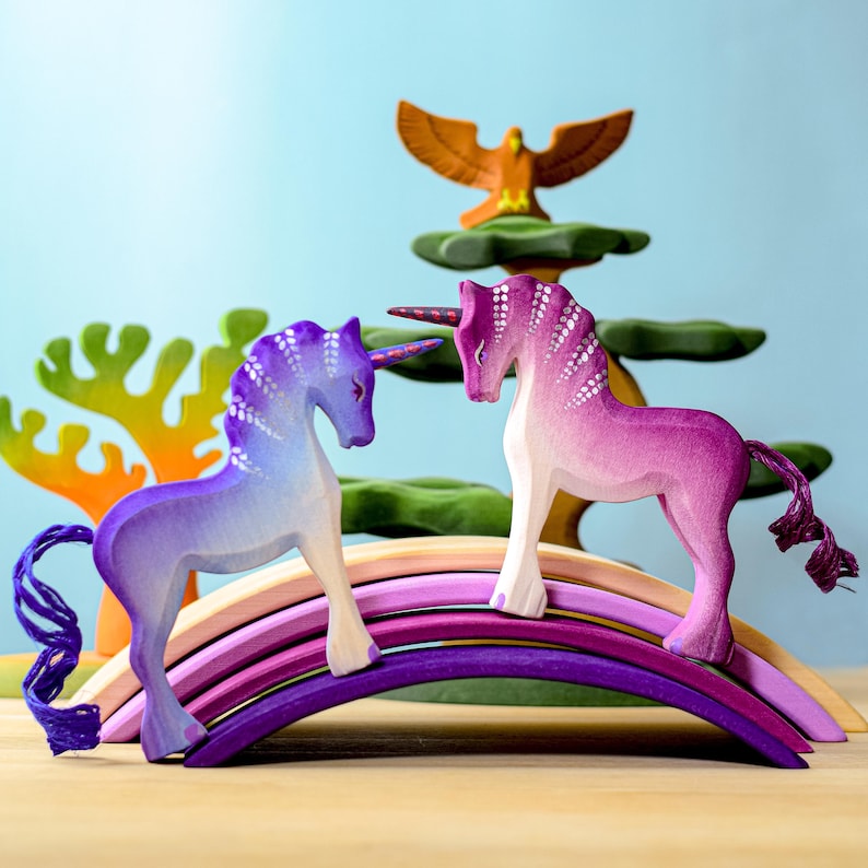 Colorful scene of two wooden toy unicorns.