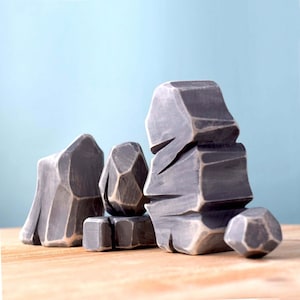 Wooden toy landscape set, with multifaceted mountains, enhancing motor skills through play.