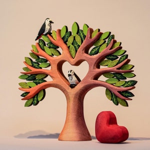 Valentine's Day inspired wooden heart tree with two wooden bird figurines perched above a heart-shaped trunk