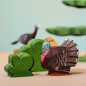 Wooden Turkey Hen Figurine alongside green bush figures, Montessori and Waldorf inspired playtime accessory