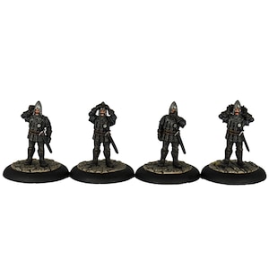 May include: Four miniature figures of medieval knights wearing black armour and helmets, holding swords and standing on round bases.
