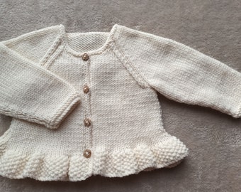 Newborn baby girls cardigan hand-knitted in a soft smooth cream baby yarn