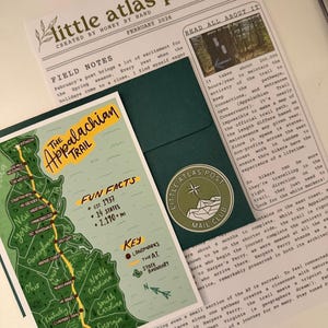 May include: A collection of stationery items featuring a map of the Appalachian Trail, a newsletter, and a mail club sticker. The map highlights landmarks and states along the trail. The newsletter includes text about the trail and its maintenance.