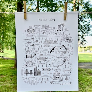 May include: Black and white illustrated map print featuring landmarks and roads. The map includes the names "ALLISON - JOEY" and various locations such as San Francisco, CA, and Lake City, CA. The print is held by wooden clothespins.