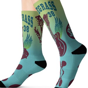 May include: A pair of blue and green socks with a graphic print of a guitar, wings, and the text "Bluegrass 38".
