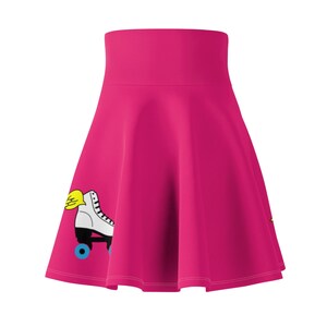 May include: A pink skater skirt with a white roller skate with yellow wings and blue wheels. The skirt has a high waist and a flared silhouette.