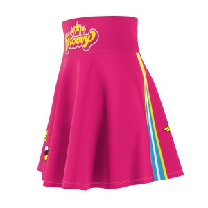 May include: A pink skirt with a high waist and a yellow and blue stripe down the side. The skirt has a yellow "Groovy" graphic with stars on the front.