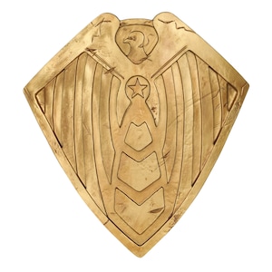 May include: A gold shield with an eagle and star design. The shield has a distressed, aged look.