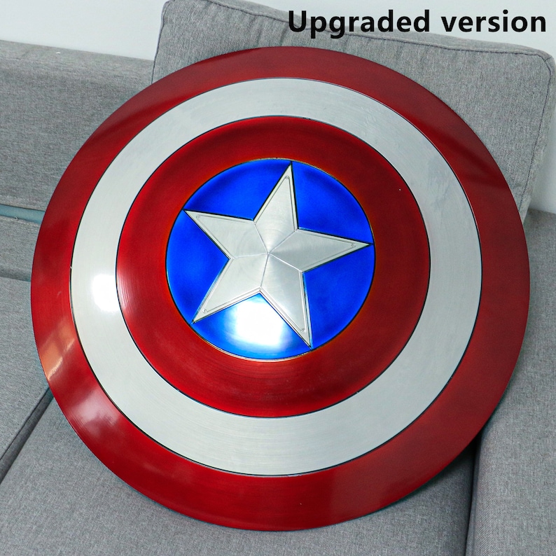 May include: A red, white, and blue Captain America shield with a five-pointed star in the center. The shield is made of metal and has a shiny finish.