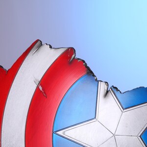 May include: A distressed shield with a red, white, and blue color scheme. The shield features a white star in the center, with red and white stripes on the left side and blue on the right. The edges are jagged, giving it a battle-worn appearance.