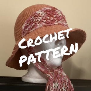 May include: A peach-colored crochet hat with a wide brim and a matching scarf. The hat features a band of pink and white crochet. The text "CROCHET PATTERN" is overlaid on the image.