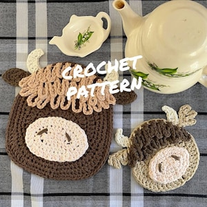 May include: Two crocheted brown and beige cow-shaped pot holders with the text "CROCHET PATTERN" in white.