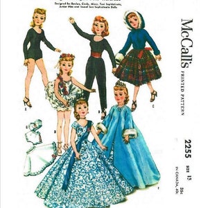 May include: A vintage sewing pattern for making doll clothes. The pattern is for McCall's 2255 and is for size 13 dolls. The pattern includes five different outfits: a black leotard, a white ballerina dress, a blue and white ball gown, a blue cape with fur trim, and a plaid skirt with a blue jacket.