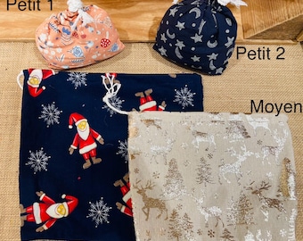 May include: A collection of fabric drawstring bags in various sizes and patterns. The bags include a small peach-colored bag with a floral design, a navy blue bag with stars, and larger bags with Santa Claus and Christmas tree patterns.