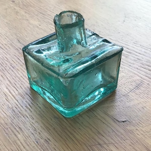 Antique Victorian green glass ink pot: square base ink bottle with pen rest