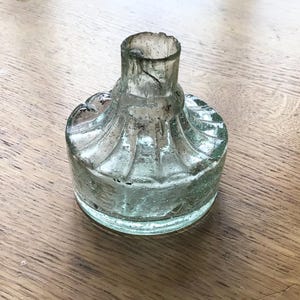 Antique Victorian glass ink pot: round base ink bottle with pen rest