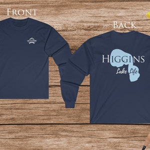 May include: A navy blue long-sleeve t-shirt with a white graphic on the front and a blue graphic with the text "HIGGINS Lake Life" on the back.