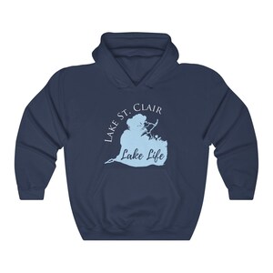 May include: A navy blue hooded sweatshirt with a light blue outline of Lake St. Clair and the text "Lake Life" in white.
