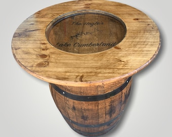 May include: A wooden barrel table with a glass top. The top has a personalized inscription that reads "The Hogle's Lake Cumberland".