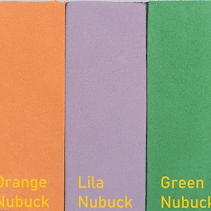 May include: Three swatches of leather in orange, lilac, and green. Each swatch has the word "Nubuck" written below it in yellow text.