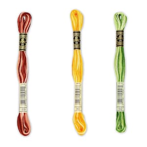 May include: Four spools of DMC embroidery floss in different colours: light blue, red and white, yellow, and green. The spools are labelled with the DMC numbers 67, 69, 90, and 92.
