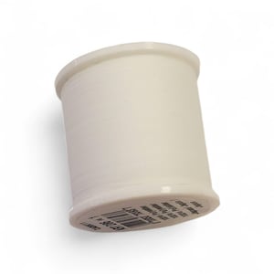 May include: A spool of off-white thread, ideal for sewing and crafting projects. The cylindrical spool is made of a light-colored material and is filled with thread. The label on the bottom of the spool is partially visible.