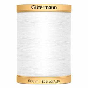 May include: A white Gütermann thread spool. The spool features gold-coloured top and bottom sections, with the brand name "Gütermann" printed on the top. The bottom of the spool displays the text "800 m - 876 yds/vgs".