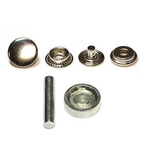 May include: A set of silver-toned metal snap fasteners, including a cap, a stud, a base, a setting tool, and a punch. The fasteners are used for attaching fabric or leather together.